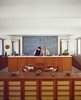 Modern home with Kitchen, Wood Cabinet, and Ceramic Tile Backsplashe. Stacey and Doug prepare food before the kitchen's massive wall of soothing tile from Heath Ceramics. Photo of 50+ Modern Tile Ideas for Walls, Floors and Ceilings