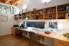 “The roof structure is exposed in every room of the house, which leads the eye to connect all of the rooms together, making the house seem bigger than it really is,” Hutchison says. Dunn Lumber supplied the laminate shelves for the study. Photo 6 of Courtyard House on a River modern home