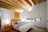 Modern home with Bedroom and Bed. “They wanted to keep the house to one level so that they could retire there without worrying about stairs and access,” Hutchison says. The home features two bedrooms, and the second one is available to guests and the homeowners’ college-age son. Photo of A Retired Couple's Secluded Home in the Forest