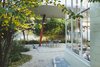 Modern home with Outdoor, Large Patio, Porch, Deck, and Stone Patio, Porch, Deck. "I wanted to preserve the canopy, the sales space, the garage door, everything," Judin tells FvF. "It wasn’t until later that I realized there was also still space for a garden." Photo 2 of An Incredible Home Inside a 1950s Gas Station