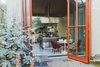 Modern home with Dining Room, Chair, and Table. "When I was furnishing the place, I made sure it’d also be a good place for art," Judin tells FvF. "After that, I considered my other passions: cooking, for example. My kitchen is the heart and center of the house." Photo 3 of An Incredible Home Inside a 1950s Gas Station