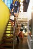 Modern home with Staircase, Metal Railing, and Wood Tread. “When I have parties, there’s always something to get people talking.”—Kenneth Montague Photo of 40+ Yellow Modern Home Design Ideas