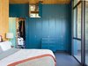 Modern home with Bedroom and Storage. In such a small space “you have to organize, and every piece takes a decision,” says resident Heidi Wright. The couple keep things they use less frequently, like guest bedding, in the higher cabinets. Photo of Our Favorite Bedrooms