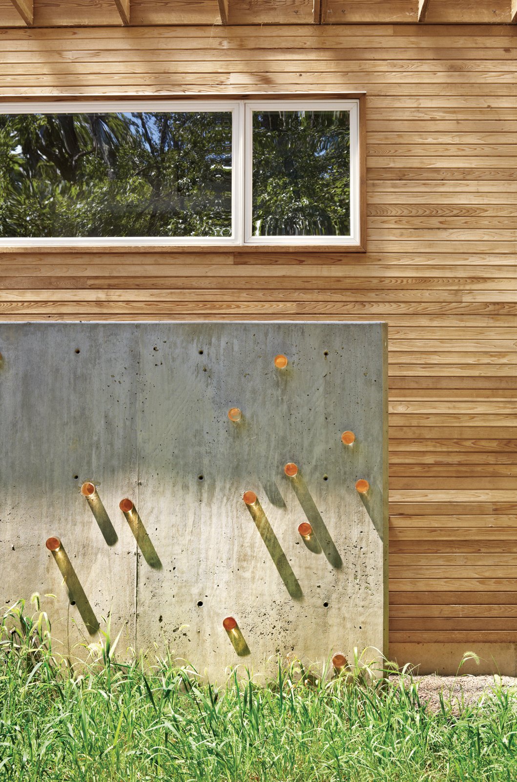 Light Show: Resolution: 4 pierced a concrete wall edging the exterior stairwell with acrylic cylinders to make a clever lighting installation. The cylinders transmit sunlight during the day, Tanney explains, and at night the installation becomes a 