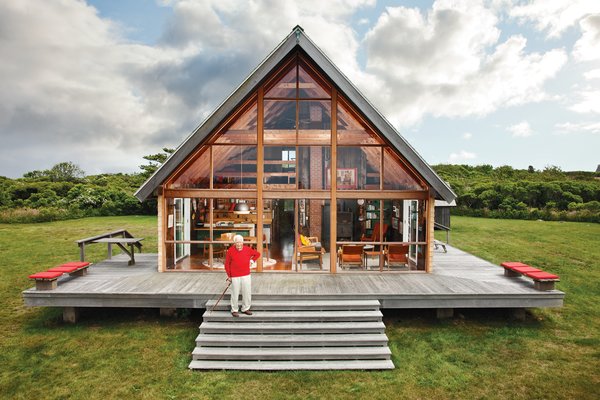 Mid-century designer Jens Risom's A-framed prefab family retreat, located on the northern portion of Block island, is bordered by a low stone wall, an aesthetic element that appears throughout the land. 