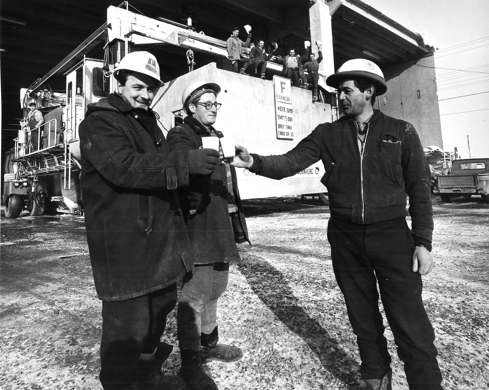 Builders toast the casting completion of the last box at Habitat ’67 in Montreal, Quebec.