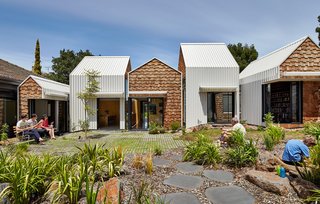 Inspired by the Sydney Opera House, architects Andrew Maynard and Mark Austin paid careful attention to the extension’s “fifth elevation"—the way it’s seen from the sky. Its tiny houses, clustered at the southern end of the property, are clad in white steel panels and western red cedar shingles, contrasting materials that emphasize their geometric forms.