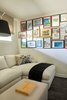 Modern home with Living Room and Sectional. The cozy den contains an A. Rudin sectional sofa upholstered in fabric from Lee Jofa. Photo of Clean Update for a Midcentury House in Pennsylvania