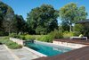 Modern home with Outdoor, Small Pools, Tubs, Shower, Swimming Pools, Tubs, Shower, Wood Patio, Porch, Deck, Small Patio, Porch, Deck, and Back Yard. The residents decided to convert a koi pond on the property into a petite pool. Next steps for the renovators are updating the kitchen and increasing its size by expanding it into the mudroom and laundry room. Photo of Clean Update for a Midcentury House in Pennsylvania