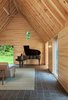 While the windows are larger than what one would find in a traditional Cape Cod structure, they were essential in establishing a connection with the forest. Photo of Tiny Cabins in the Vermont Woods Commune With Nature modern home