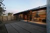 A horizontally-clad pine fence surrounds the home, giving its residents a measure of privacy at night despite the floor-to-ceiling windows. Photo of 30+ Best Modern Fences modern home