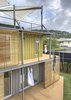 Modern home with Exterior, House Building Type, and Shipping Container Building Type. The firepole is an extra amenity the client always wanted to include in his home. Photo of Who Knew a Relaxing Tropical Retreat Could Be Made of Shipping Containers