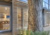 Modern home with Windows, Sliding Window Type, Wood, and Metal. Sliding bamboo panels on the west side of the house can be adjusted to provide shade during the later part of the day. Photo of Who Knew a Relaxing Tropical Retreat Could Be Made of Shipping Containers