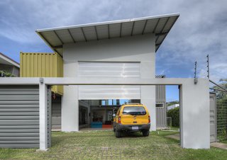 The slanted roof above the garage, painted white to reflect the heat in the tropical environment, also contains a solar heating system for water. The home also features a rainwater collection system, particularly useful during the long rainy season.