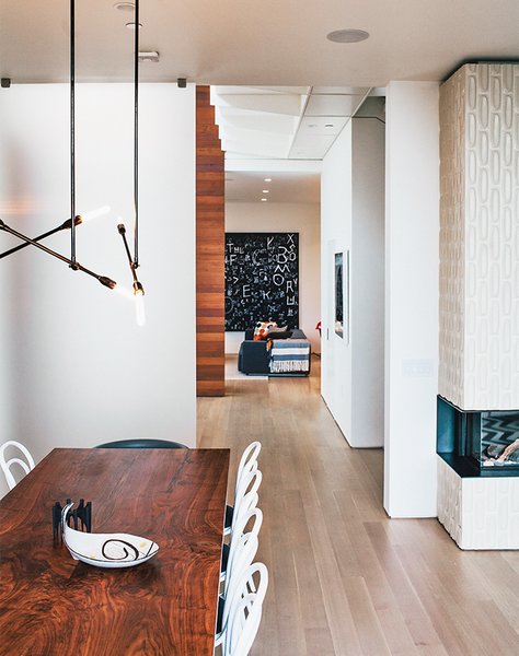 The catwalk above leads to the master bedroom. The living-dining room’s Stix chandelier is from Nido Living.