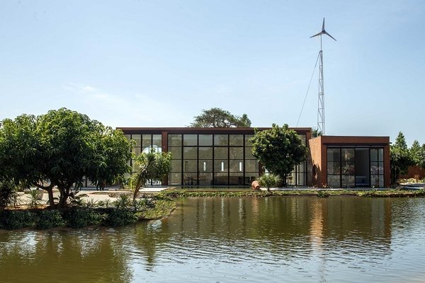 The Khamsa home in Senegal, built with earth bricks and energy independent due to solar panels and a wind turbine, was actually 15 percent cheaper to build than a traditional home.  The walls, which are thicker than those used in standard concrete construction, help moderate the interior temperature in a region where the climate swings from dry to humid throughout the year, absorbing humidity and cooling the home during warm weather while moderating temperature and improving indoor air quality.