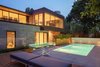 The cantilevered extension is clad in anthracide-colored concrete panels that reflect the limesone that was used to line the swimming pool. Photo 7 of Prince-Philip Residence modern home