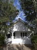The façade of the interwar dwelling was painted bright white and left largely unchanged, with a sole burst of color coming from a yellow DesignByThem “tomtom” letterbox. Though the extension is invisible from the street, architect Christopher Polly says it provides “significant additional freedom for the owners and their three young children to grow into.” Photo 2 of Cosgriff House modern home