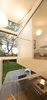 Thanks to the extension’s vaulted ceiling, the master bedroom and minimalist staircase have views of the sky. Polly admits to having sacrificed floor area so that the full-height stairwell could achieve a stronger connection with the outdoors. Toyo Ito Mayhuma pendants hang from the ceiling, accentuating the space’s dramatic height. Photo 8 of Cosgriff House modern home