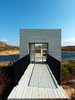 Modern home with Exterior, Wood Siding Material, Cabin Building Type, and Flat RoofLine. Those seeking isolation and inspiration to tackle their work need look no further. A minimalist cube set against a picturesque background form a studio free of distraction, except maybe that view! Newfoundland, Canada. By Saunders Architecture from the book Rock the Shack, Copyright Gestalten 2013. Photo of Stunning Waterfront Structures