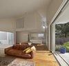 Open brickwork on the cantilevered playroom makes it easier for parents to hear what’s happening inside while also adding visual interest to the white walls. Photo 2 of Riverview modern home