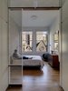 The screens and shelving from the kitchen area repeat in the master bedroom, filtering light to the closet area, through which the master bedroom is accessed. The dresser was designed by BSC. Photo of Our Favorite Bedrooms modern home