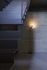 Pitsou Kedem's unique twist in the new basement is a two-part metal staircase with a gap in the middle. A slim Parentesi Floor Lamp illuminates the space. Photo 4 of Minimal Reboot modern home