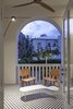 The narrow balcony helps shade the residents while funneling the cool ocean breeze from the west. Photo 7 of Minimal Reboot modern home