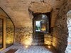Parts of the interior still maintain an earthy, subterranean atmosphere. Catacombs are hidden below the finished rooms above. The stairs lead to an outdoor area designed for communal interaction. Photo 7 of Scaiano Stone House modern home