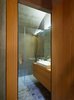Custom case work and a polished wall give the bathroom a warm yet minimal look. Photo 8 of Scaiano Stone House modern home