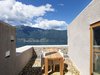 Despite the raw materials and rocky walls, the upstairs terrace feels positively weightless, offering spectacular views of Lago Maggiore. Photo 9 of Scaiano Stone House modern home