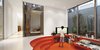 Modern home with Living Room, Bench, Concrete Floor, Recessed Lighting, and Ceiling Lighting. The sunken family room is enlivened by Alvarez-Calderón’s addition of fabrics from Designers Guild and glossy paint. Photo of How to Design with Orange