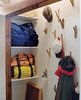 Modern home with Storage Room and Closet Storage Type. In the closet stick-like wall hooks continue the rural motif. Photo 14 of New Grass Roots