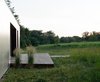 Modern home with Outdoor, Wood Patio, Porch, Deck, and Small Patio, Porch, Deck. The design for the exterior of the house keeps things super simple—a small deck bridges the door with the grassy meadow, but allows the meadow itself to be the focus of the home's outdoor space. Photo 18 of New Grass Roots