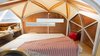 Katrina Manzo explains the pair’s 44-square-foot mobile prototype as “both reductive and luxurious.” Its automotive structure is assembled in-house from the studio’s own kit of parts, with help from CNC milling which Manzo says “marries precision and consistency with the capacity to manufacture in small volumes.” Photo of A 44-Square-Foot Prefab Trailer modern home