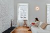 “Using white allowed me to lighten up small interior spaces and at the same time respect the original colors of the carpentry and stucco work,” Rocha says. East-facing windows also catch the warm morning sun and minimize the need for artificial lighting. Photo of Minimal Apartment in Lisbon Divvied Up by Sliding Doors modern home