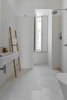 Modern home with Bath Room, Open Shower, Wall Mount Sink, and Subway Tile Wall. White tiles — hydraulic ones on the floor and “biselado” (meaning “beveled”) ones on the walls — make for a tranquil bathroom. Photo of Minimal Apartment in Lisbon Divvied Up by Sliding Doors