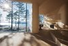 The architects designed the large glass expanses in the dining and living areas so that their frames are hidden from view. “I love the way the light comes into the cabin and meets the curved surfaces of the walls and ceilings,” Bae Brandtzæg says. The kitchen’s custom cabinets were designed by Atelier Oslo and constructed by the contractor, Byggmester Bård Bredesen. The gas-powered stove, oven, and fridge are by VERA. Photo 4 of Cabin Norderhov modern home
