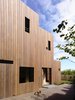The property is not just steep, but also narrow, which limited the type of scenery and sunlight the previous addition's rooms enjoyed. Kennon engineered the west side of the new house to zigzag inward, permitting both south- and west-facing windows in each section. The slanted western windows also tilt slightly north, which brings in more light. “That’s how you can get winter sun and afternoon sun into the house, whereas previously the addition didn’t have any relationship to the sun,” Kennon explains. Photo of Lush Hill modern home