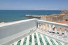 The rooftop terrace, covered in a different tile pattern, offers a stunning view of Cefalu and the northern Sicilian coast. Photo of A Mind-Blowing, Mondrian-Esque Staircase modern home