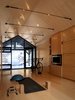 An ethanol-burning fireplace adds warmth in colder months. The reinforcing rods above provide additional structural support to the enlarged Bunkie. Photo of High-Tech Prefab Outbuilding is a Surprisingly Peaceful Retreat modern home