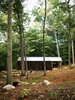 Modern home with Exterior, Cabin Building Type, Metal Roof Material, and Gable RoofLine. The roof is anodized aluminum and, thanks to the wooden cladding, the Bunkie blends nicely into its forested surroundings. Photo of High-Tech Prefab Outbuilding is a Surprisingly Peaceful Retreat