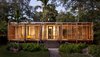 The 1,500-square-foot home features a striking interplay of sharp glass and soft wood shutters, creating a simple and practical building that’s rich in cultural heritage. The home takes inspiration from many native building styles, including postwar tropical modernism, glass pavilion typology, and Florida cracker architecture. The dense ipe wood that clads the exterior and columns was chosen to withstand potential termite attacks and the damp tropical climate. Photo of Brillhart House modern home