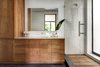The master bathroom extends the same visual themes found throughout the rest of the home to keep the overall scheme unified. Ipe wood was used for the shower flooring and lightly oiled cherry wood forms the cabinets. Photo 6 of Brillhart House modern home