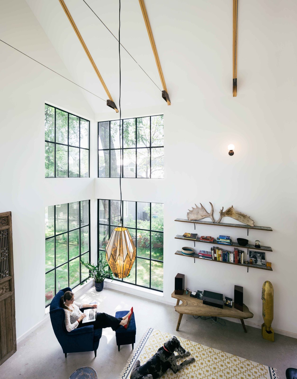 Concerned about the chemicals involved in laminate flooring, the couple chose to leave the concrete slab, the foundation of the home, exposed, almost eliminating flooring expenses. A local craftsman made the windows, using Texas pine for framing. The floor-to-ceiling windows, Pavonetti says, reduces the couple's need for lights.