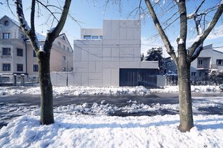 Architect Rok Oman of OFIS Architects started the renovation of what would become Villa Criss-Cross by tackling a thorny site issue. Since it is located close to the street and perpendicular to the old Roman wall near Ljubljana's ancient fortress, zoning laws require buildings to be set four meters back from the street. By maintaining the original wall and adding steel panels, Oman grandfathered in the new structure and maintained the original orientation.