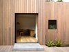 A timber rain screen made of locally-sourced spotted gum clads the house. “It’s basically like a tortoise shell in that it’s a protective layer, a shield, that allows the building to be protected from the sun and insulated from the cold,” Kennon says. Because of its high density, the Australian hardwood stands up well against the elements. Photo 2 of Lush Hill modern home