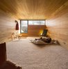 Modern home with Kids Room and Bedroom. Downstairs, bedrooms and a library offer private spaces. Wide-plank blond wood wraps the walls, floors, and ceilings, creating a cozy shiplike experience. Photo 7 of Refuge