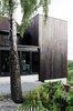 A simple black box in many ways, the Ankersvingen Annex succeeds with its simplicity; it adds space without subtracting from the surroundings. “It was a really neat connection between the house and garden, which was totally lacking with the existing architecture,” says architect Thor Olav Solbjør of SAAHA. “We took the stunning views of the fjord as the starting point.” Photo of Charred Cedar modern home