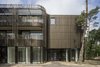 Manufactured by Remota, the bronze anodized aluminum facade curves around the building. Photo 2 of Kerckebosch modern home